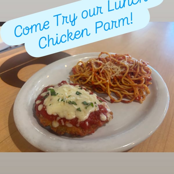 Chicken parmesan with melted cheese and spaghetti, with 'Come Try our Lunch Chicken Parm!' text.
